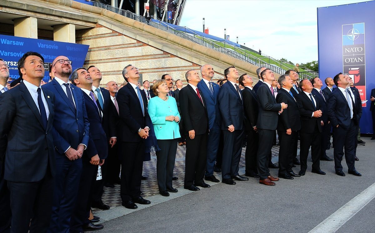 NATO Secretary General Jens Stoltenberg, Italian Prime Minister Matteo Renzi, German Chancellor Angela Merkel, President of Turkey Recep Tayyip Erdogan watch NATO military aircraft fly past during the Warsaw NATO Summit on July 8, 2016 in Warsaw, Poland.