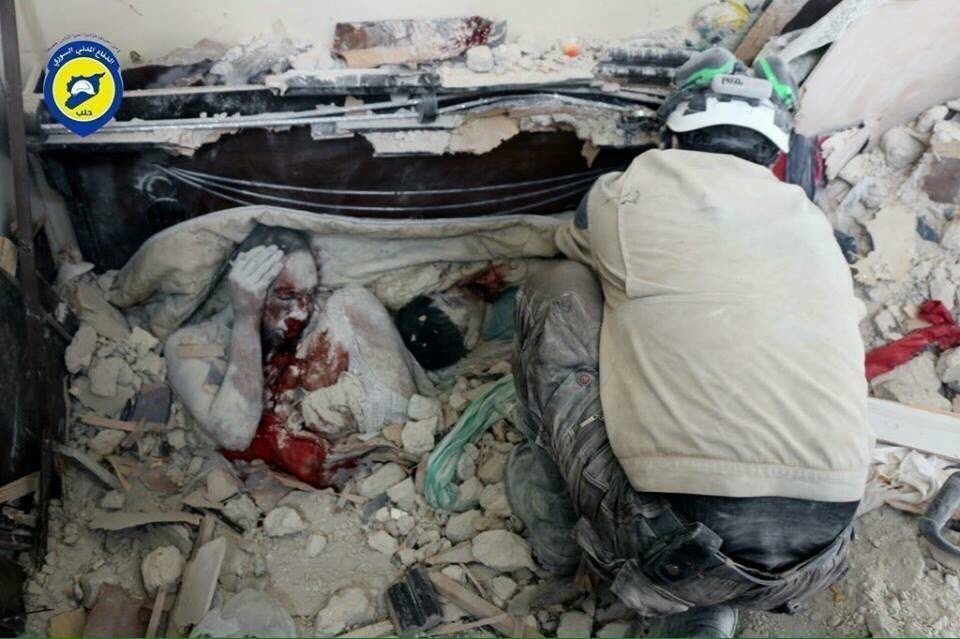 a whole family, a mother and her two kids, buried under the rubble of their house after Assad regime's airstrikes